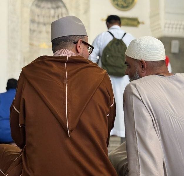 Tayseer travelers seated inside the mosque
