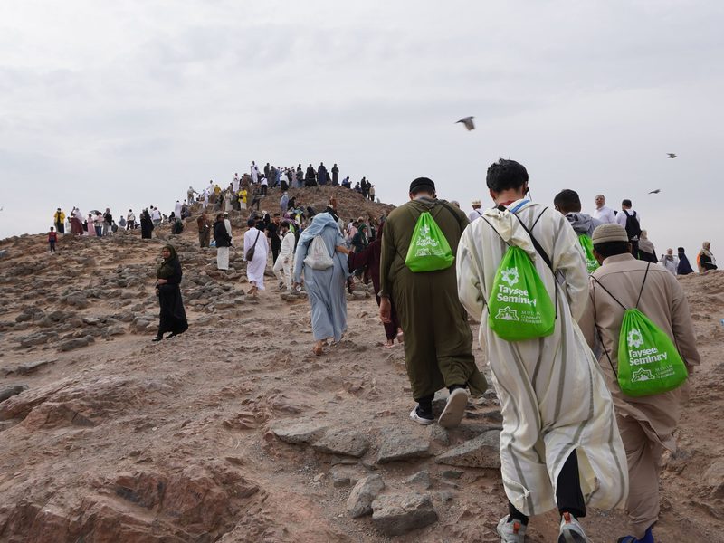 Tayseer Umrah travelers walking on a hill