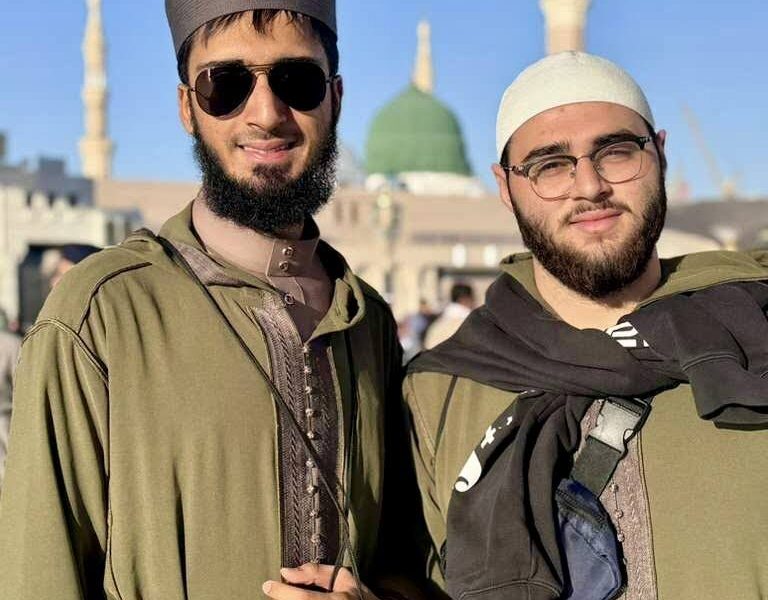 Two Tayseer Umrah travelers outside the mosque